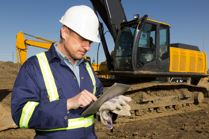 Man using tablet to input inspection data in the field.